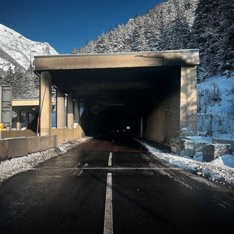 Tunnel surrounded by snow and mountains